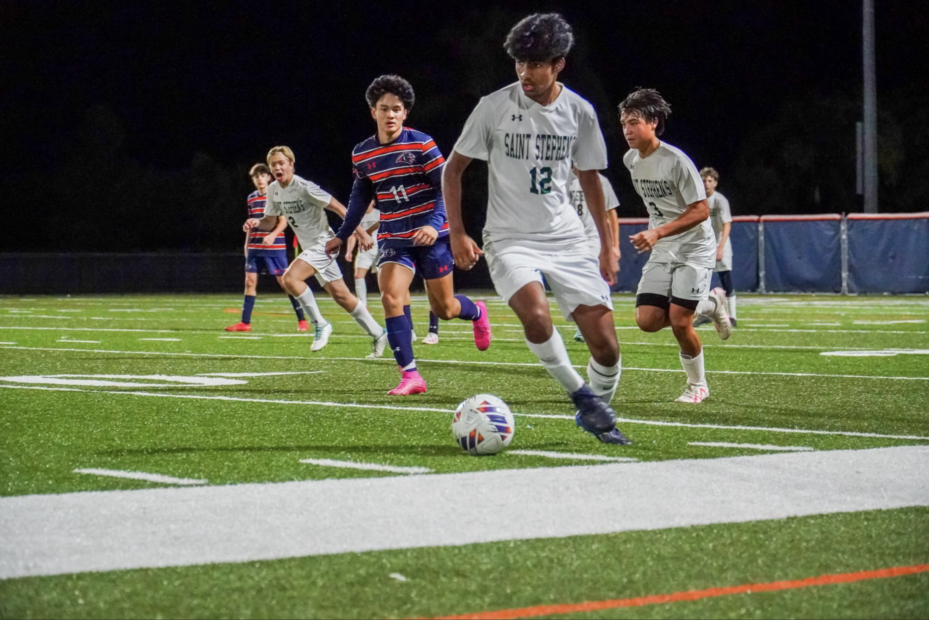 Midfielder Sanjay Dasitdar possesses ball with Gabe Conn close behind.